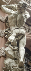 male figure sculpture on the facade of an old house in Art Nouveau style
