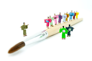 Miniature Japanese peoples walking on paintbrush