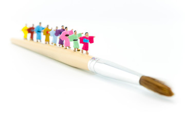Miniature Japanese peoples walking on paintbrush