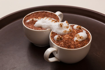 Coffee with foam in the form of cat and mouse