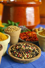 Collection of different spices in old clay bowls in colorful oriental style