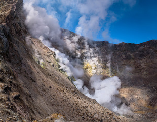 Steamy fumaroles inside Mutnovsky Volcano crater, Kamchatka, Russia