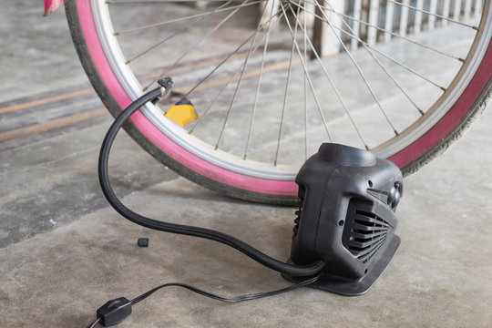 Tire inflate to pink bicycle