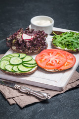 Fototapeta na wymiar Vegetarian sandwiches with cream cheese and vegatables