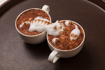 Coffee with foam in the form of cat and mouse