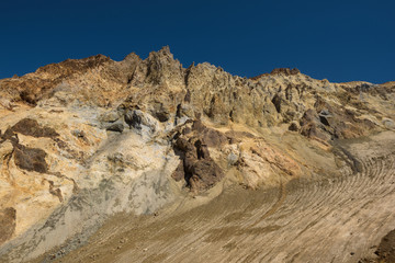 Fototapeta na wymiar Rocky cliffs around the crater of Mutnovsky volcano, Kamchatka, Russia