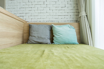 Green bed and colorful pillows
