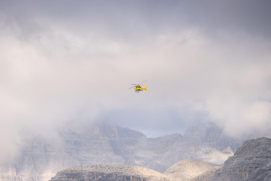 Medical rescue helicopter in air. Italian Dolomites.
