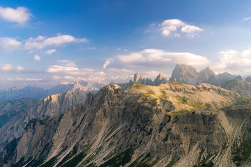 Obraz premium Horizontal view of dramatic mountains landscape. Photo of summer landscape in Italian Dolomites. Beautiful evening golden light. UNESCO World Heritage Site.