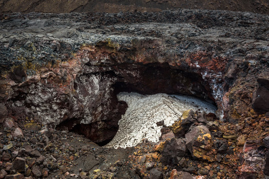Lava pit between lava streams filled with snow, Tolbachik Volcano, Kamchatka, Russia