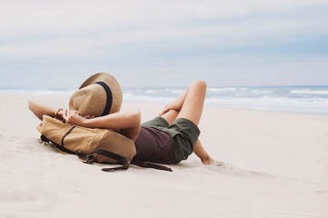 Young woman lying on a beach. Relaxation concept