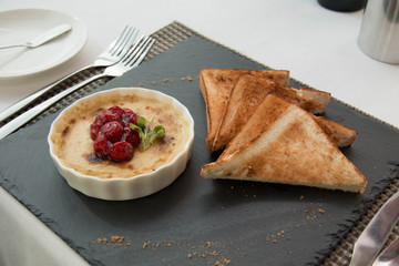  delicious Creme Brulee with cherry and bread