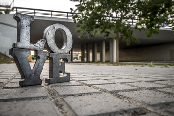 Love sign with metal letters in a street