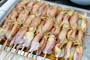 Fresh squid yellow stab arranged on tray