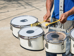 Men hitting the drum