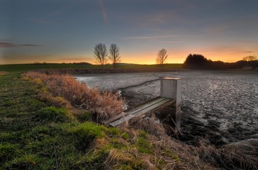 December sunset by the pond after harvesting