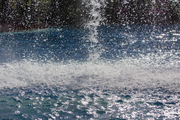 Fototapeta na wymiar effect and splash water from water fall in swimming pool