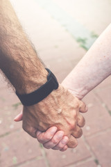 Adult couple holding hands on the street