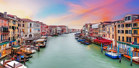 Venice Grand Canal gondolas, hotels and restaurants at sunset fr