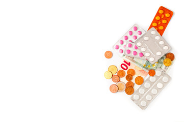 Pills and Euro money on white background