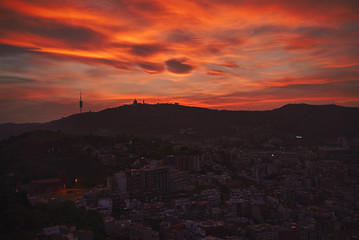 Dramatic shot of Barcelona skyline and downtown under sunset sky