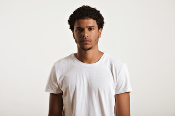 Serious muscular African American model wearing a blank white cotton t-shirt looking into the camera