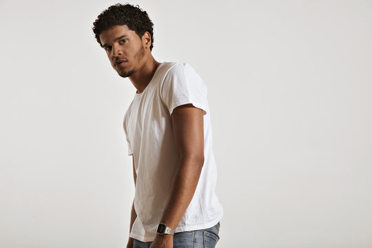 Sexy muscular African American man in white unlabeled cotton t-shirt turning sideways and looking into the camera