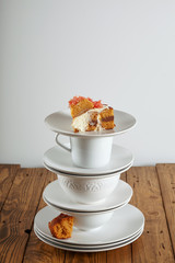 A slice of moist delicate brown sponge cake with grapefruit on several cups in a pyramid