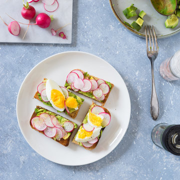 Avocado toast with radishes and boiled egg