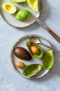 Halved avocados, its shells and seeds