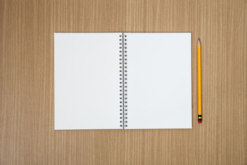 Blank empty notepad and pencil on wood table