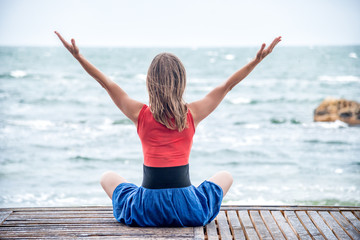 Woman meditating at the sea