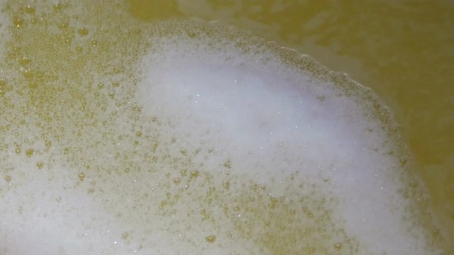 Fermenting must. Carbon dioxide is visible during the fermentation process in the form of bubbles in the must.