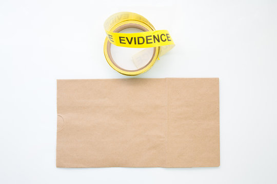 Evidence Marker Tape And Paper Bag In Crime Scene Isolated On White Background