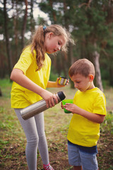 happy children hiking in the forest