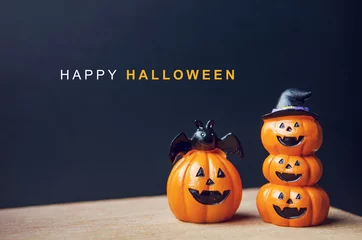 Fototapeten Happy Halloween message, Pumpkin on table wood with dark wall background, halloween concept. © oatawa