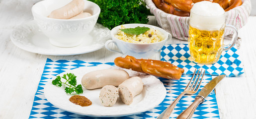 Fototapeta na wymiar Bavarian sausage with pretzel, sweet mustard and beer