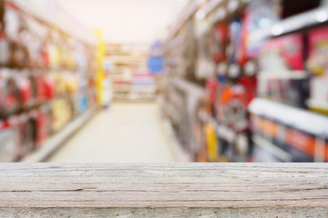 wood table top with supermarket Aisle and Shelves in blur backgr