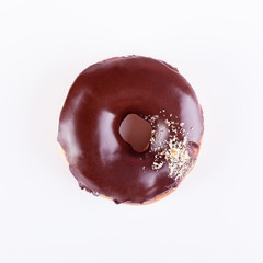 Delicious donut with chocolate glaze and sprinkles on a white background. Top view