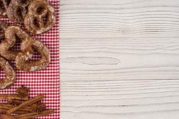 Gingerbread heart cookies on a wooden white background.