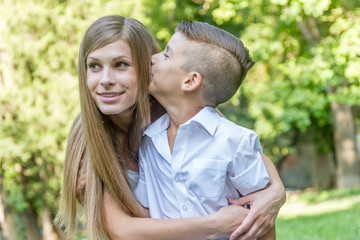 outdoor portrait of young handsome child boy with his mother