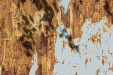 Rusty steel garage door. Strips of rusting as the strokes of paint on a gray metal background. The...