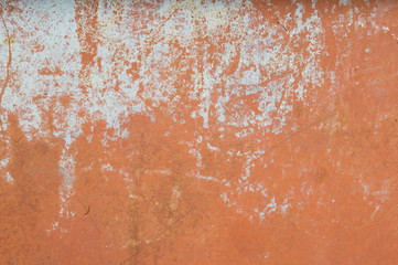 Plastered scratched wall with peeling paint in biue  and pink colors