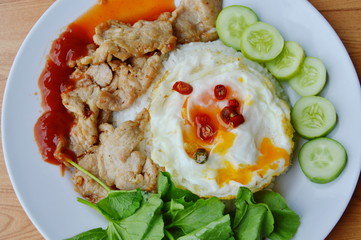 fried pork with garlic and pepper topping creamy egg yolk on rice