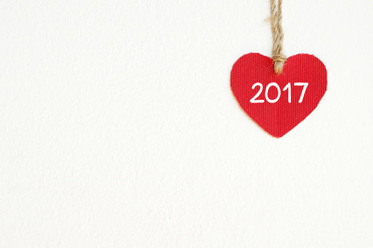 Red fabric heart with 2017 word white wall background