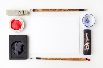white paper sheet mockup with calligraphy tools. Flat lay. Top view