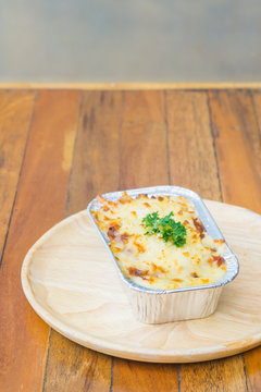 Homemade lasagne bolognese on wood table