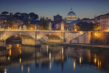 Rome. View of Vittorio Emanuele Bridge and the St. Peter's cathedral in Rome, Italy at night.