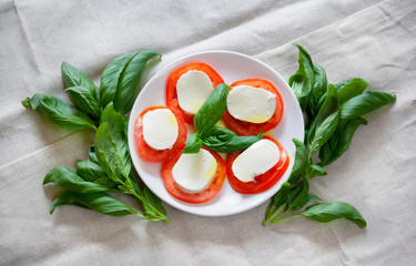 Caprese salad with mozarella cheese, tomatoes and basil
