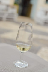 Close up on glass of white wine on the table background